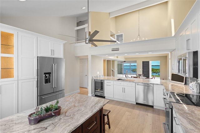 71 Tidy Island Blvd, Bradenton, FL 34210 - kitchen featuring light stone counters, wine cooler, a sink, stainless steel appliances, and ceiling fan