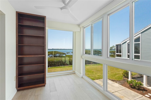 71 Tidy Island Blvd, Bradenton, FL 34210 - unfurnished sunroom with a water view, baseboards, and wood finished floors