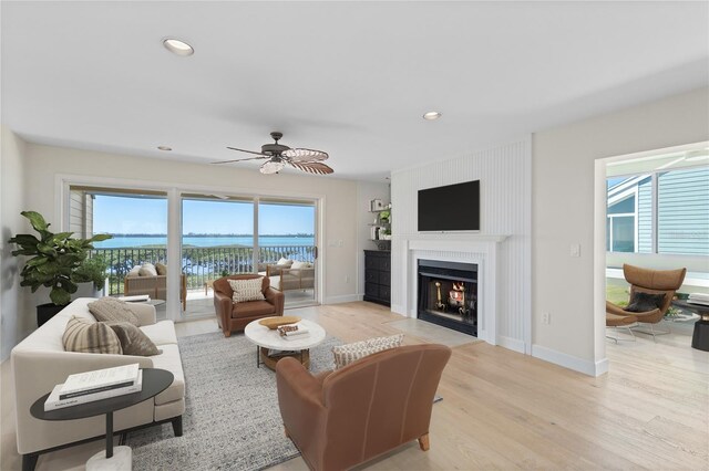71 Tidy Island Blvd, Bradenton, FL 34210 - living room featuring a fireplace with flush hearth, baseboards, ceiling fan, recessed lighting, and light wood-type flooring
