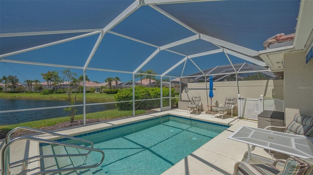 outdoor pool featuring a lanai, a patio, and a water view