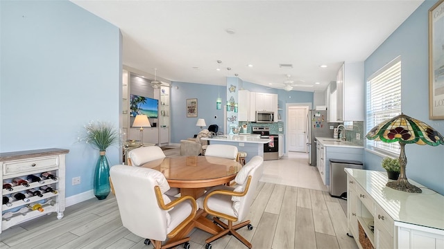 dining area featuring baseboards, wood tiled floor, and ceiling fan