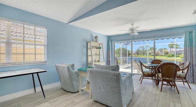 dining room with baseboards, a ceiling fan, lofted ceiling, and light wood finished floors