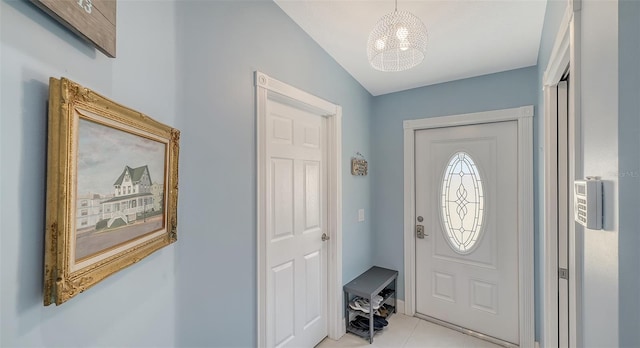 entryway featuring light tile patterned floors and a chandelier