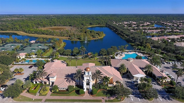 bird's eye view with a water view and a wooded view