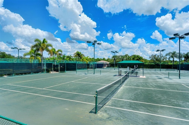 view of tennis court featuring fence