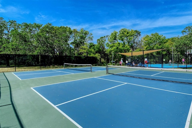 view of sport court featuring fence and community basketball court