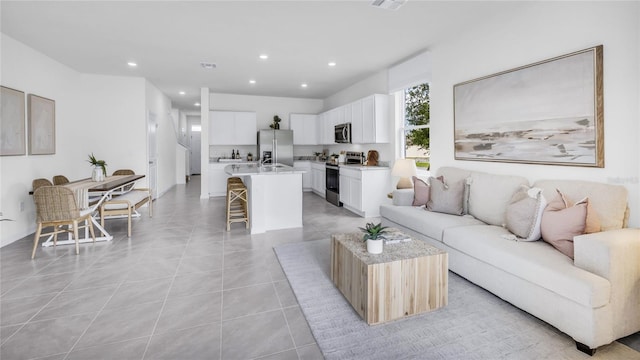 2481 Mellow Ln, Clearwater, FL 33765 - living room with visible vents, recessed lighting, and light tile patterned floors