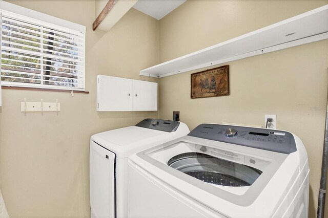 clothes washing area featuring washer and dryer