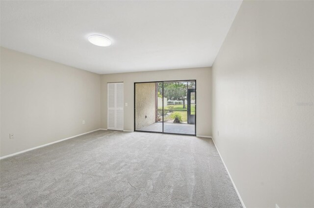 spare room with carpet and baseboards
