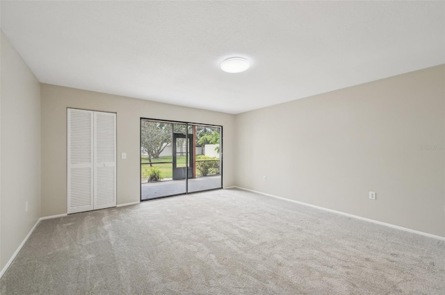unfurnished room featuring baseboards and carpet
