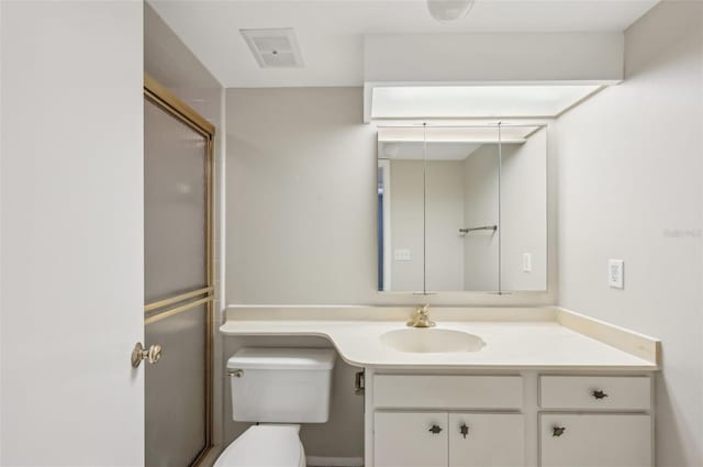 full bathroom featuring toilet, vanity, a shower with door, and visible vents