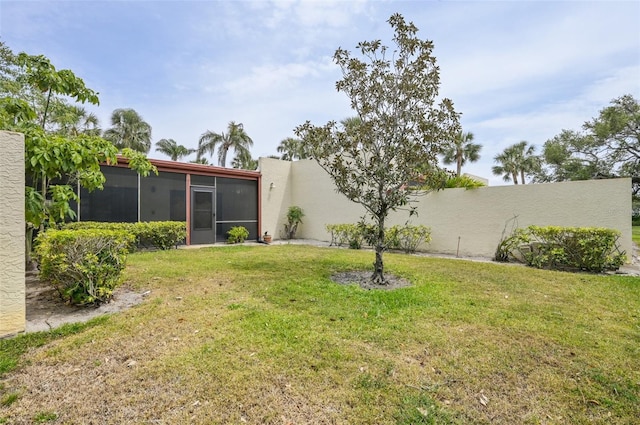 view of yard with a sunroom and fence