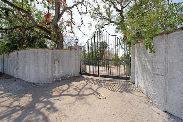 view of gate with fence