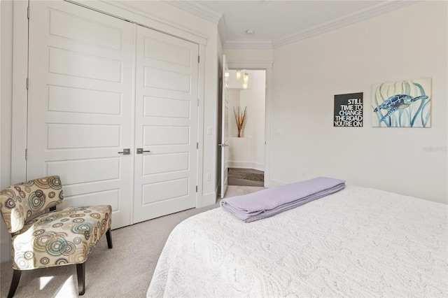 bedroom with a closet, carpet floors, and crown molding