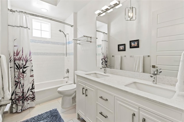 full bath featuring double vanity, shower / bathtub combination with curtain, a sink, and toilet