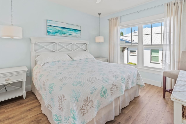 bedroom with baseboards and light wood-type flooring