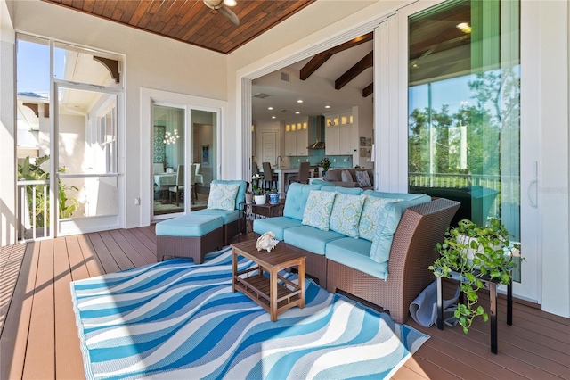 sunroom with outdoor lounge area, ceiling fan, visible vents, and beam ceiling