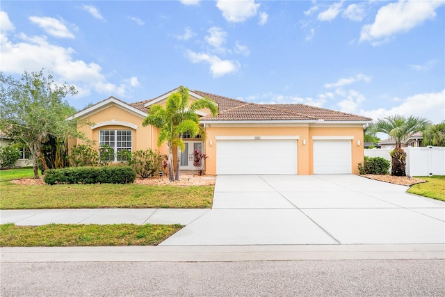 1189 Fraser Pine Blvd, Sarasota, FL 34240 - view of front of house with stucco siding, fence, driveway, and a garage