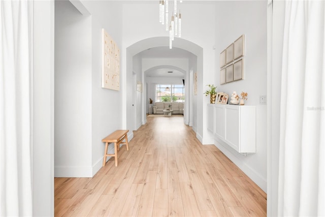1189 Fraser Pine Blvd, Sarasota, FL 34240 - corridor featuring light wood-type flooring, baseboards, and arched walkways