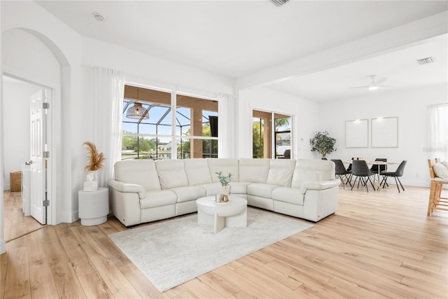 1189 Fraser Pine Blvd, Sarasota, FL 34240 - living area with visible vents, arched walkways, a ceiling fan, and light wood-style floors