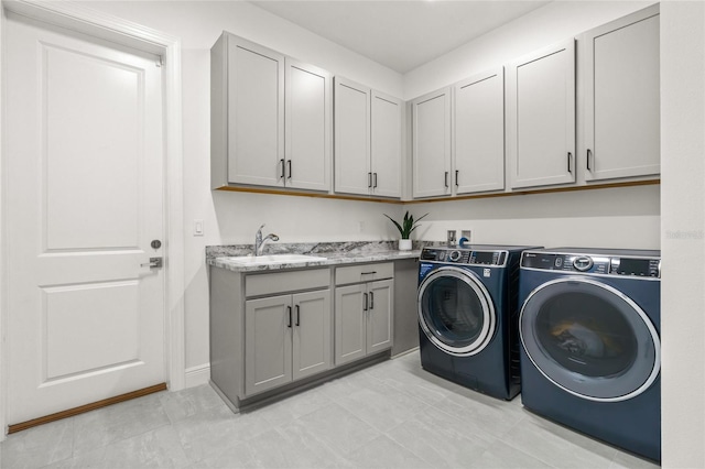 laundry room with washer and clothes dryer and cabinet space