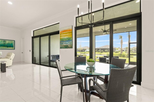 dining room featuring healthy amount of natural light, crown molding, baseboards, a ceiling fan, and recessed lighting