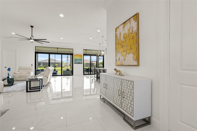hall featuring recessed lighting, light marble finish flooring, and baseboards