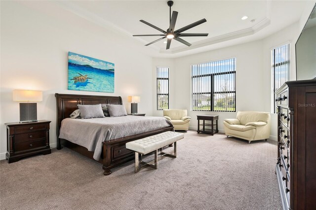 bedroom featuring a tray ceiling, light carpet, multiple windows, baseboards, and recessed lighting