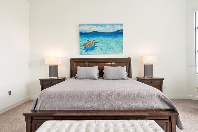 carpeted bedroom featuring baseboards
