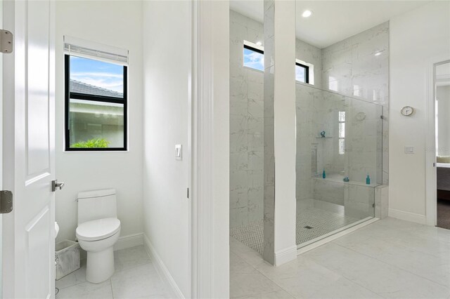 full bathroom with a stall shower, toilet, baseboards, marble finish flooring, and recessed lighting