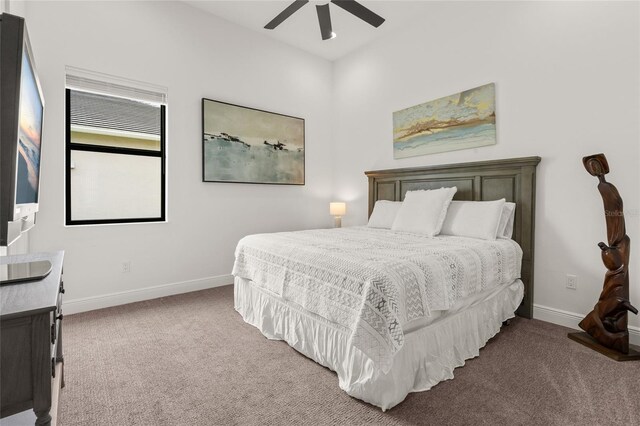 bedroom featuring carpet flooring, baseboards, and a ceiling fan