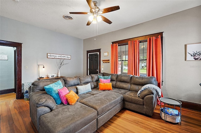 501 Washington Ave, Eustis, FL 32726 - living room featuring a textured ceiling, visible vents, a ceiling fan, and hardwood / wood-style floors