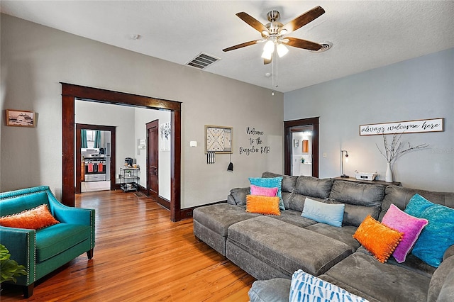 501 Washington Ave, Eustis, FL 32726 - living area with a ceiling fan, visible vents, a textured ceiling, and wood finished floors