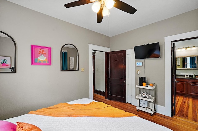 501 Washington Ave, Eustis, FL 32726 - bedroom with wood finished floors, ceiling fan, and ensuite bathroom