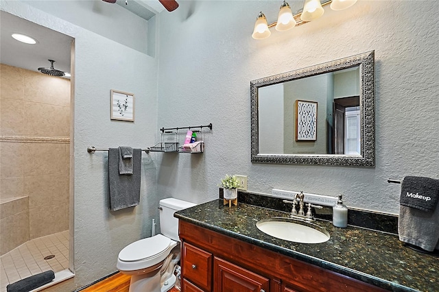 501 Washington Ave, Eustis, FL 32726 - bathroom with toilet, vanity, a textured wall, and tiled shower