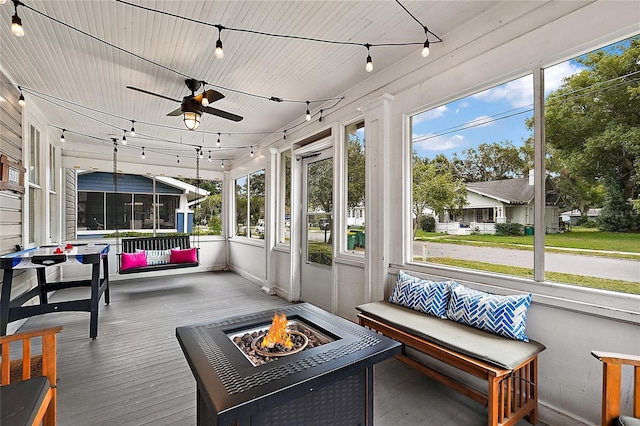 501 Washington Ave, Eustis, FL 32726 - sunroom / solarium featuring rail lighting, ceiling fan, and an outdoor fire pit