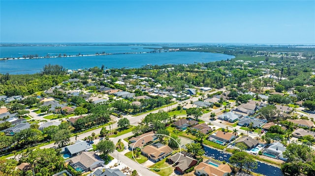 birds eye view of property with a water view and a residential view