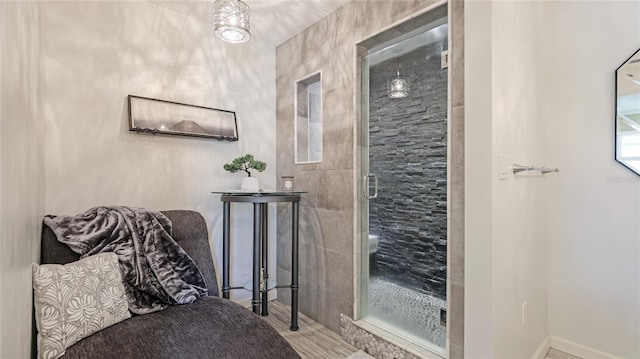 full bath featuring baseboards and a stall shower