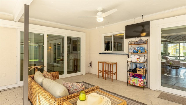 sunroom featuring ceiling fan