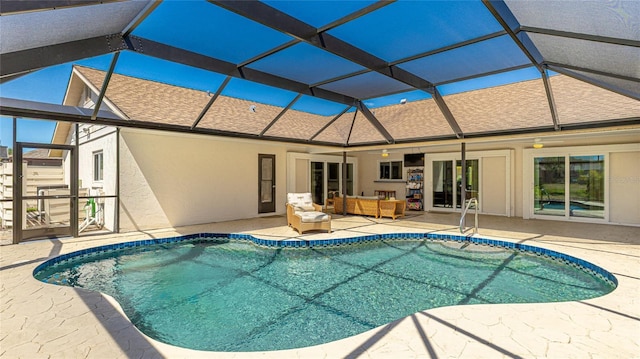 pool with glass enclosure, a patio, ceiling fan, and an outdoor hangout area