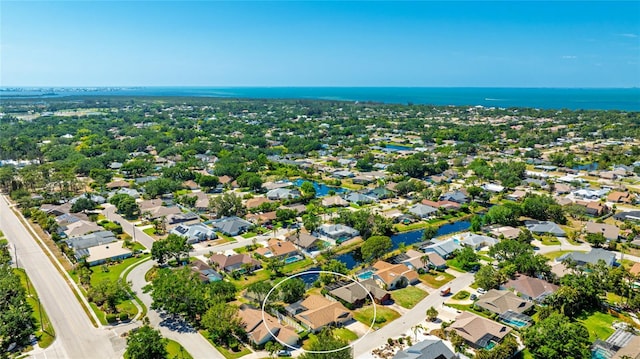 birds eye view of property featuring a water view and a residential view