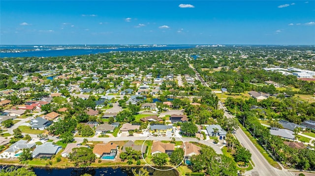 birds eye view of property featuring a water view and a residential view