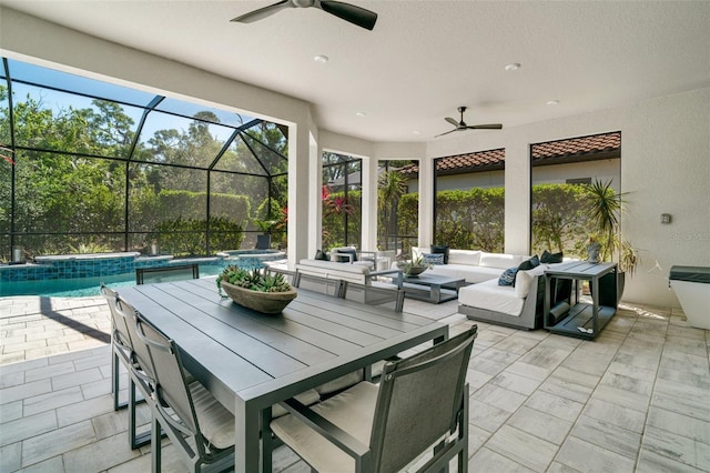 view of patio / terrace featuring ceiling fan, a lanai, outdoor dining space, and an outdoor living space