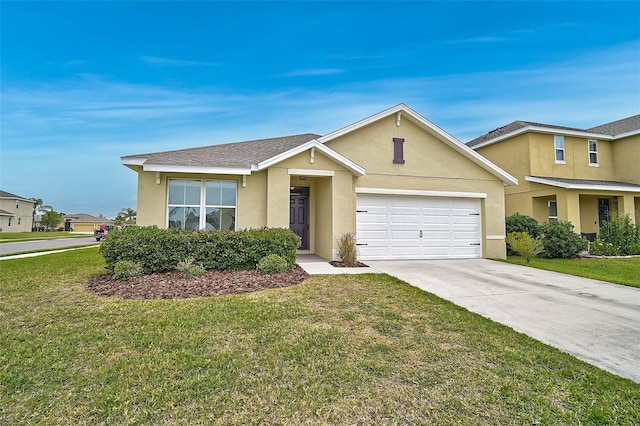 view of front facade with a front yard, driveway, stucco siding, and an attached garage