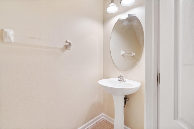 bathroom with baseboards and tile patterned flooring