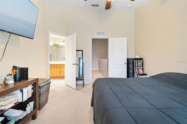 bedroom featuring light colored carpet, ceiling fan, a towering ceiling, and visible vents