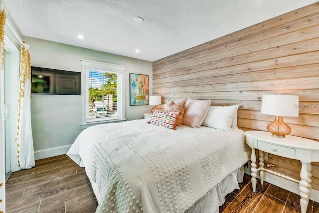 336 Avenida De Mayo, Sarasota, FL 34242 - bedroom with wooden walls, a textured ceiling, baseboards, and wood tiled floor