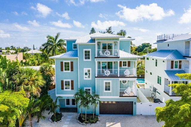 336 Avenida De Mayo, Sarasota, FL 34242 - view of front of home with a balcony, a gate, metal roof, fence, and a standing seam roof