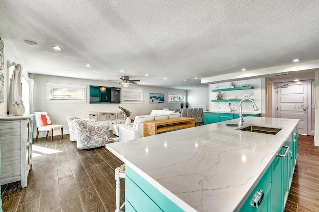 336 Avenida De Mayo, Sarasota, FL 34242 - kitchen featuring a center island with sink, a sink, dark wood-type flooring, and ceiling fan