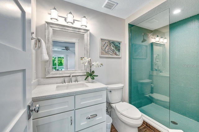 336 Avenida De Mayo, Sarasota, FL 34242 - bathroom featuring a textured ceiling, visible vents, toilet, vanity, and tiled shower